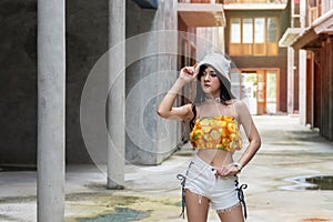 Attractive woman standing at city and town style Chinese fell lonely. Fashionable pretty girl long hair wearing hat