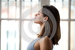 Attractive woman standing with closed eyes ready for yoga classe