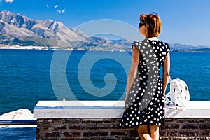 Attractive woman standing on the Gaeta sea coast photo