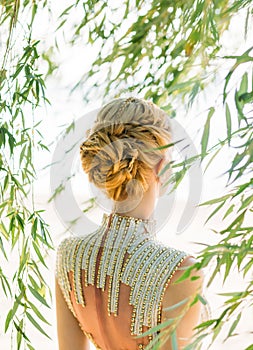 Attractive woman with straight blond blond hair, braided in a soft hairstyle of braids for a princess or elf, neat