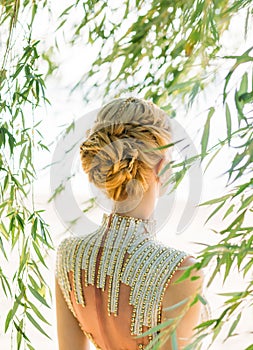 Attractive woman with straight blond blond hair, braided in a soft hairstyle of braids for a princess or elf, neat photo