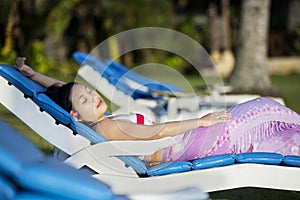 Attractive woman sunbathing at beach resort