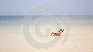 attractive woman sunbathing in gorgeous crystal water,cambodia
