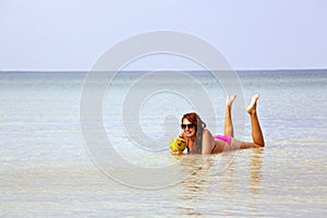 attractive woman sunbathing in gorgeous crystal water, cambodia