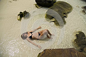 attractive woman sunbathing in gorgeous crystal water, cambodia