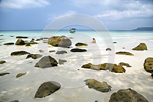 attractive woman sunbathing in gorgeous crystal water, cambodia