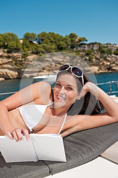 Attractive woman sunbathing on luxury boat