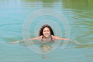 Attractive woman swimming in a lake