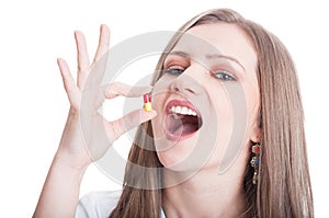 Attractive woman taking antibiotic pill