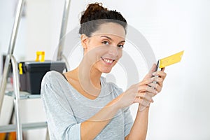 Attractive woman tinkering in home workshop