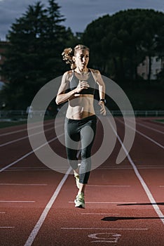 Attractive woman Track Athlete Running On Track.