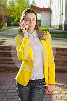 Attractive woman using cellphone outdoors.