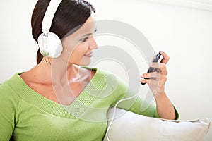 Attractive woman using a portable music player