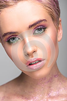 attractive woman with violet makeup looking at camera