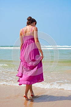 Attractive woman walking in to the ocean