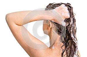 Attractive woman washing hair with shampoo in shower