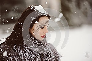 Attractive woman in white and gray fur coat