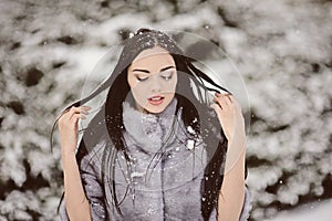 Attractive woman in white and gray fur coat