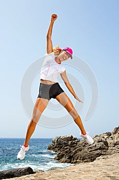Attractive woman with winning attitude jumping.