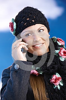 Attractive woman in winter clothes with mobile