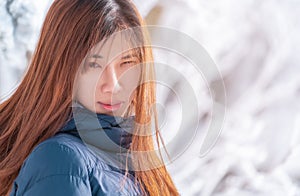 attractive woman with winter fashion clothing with beautiful skin face in snow skii resort, closed up portrait