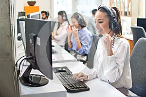 Attractive woman working with customer on hotline support in call center