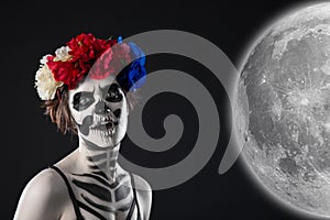 Attractive woman in a wreath with sugar skull make-up