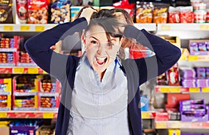 Attractive woman yelling or screaming in grocery s