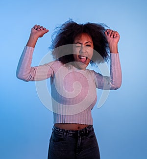 Attractive yong african american woman dancing and having fun in moody disco light