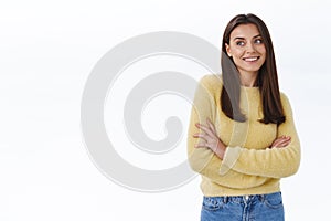 Attractive young adult caucasian woman in yellow sweater with no blemishes, no makeup, look left blank white space as