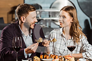 Attractive young adult couple having dinner