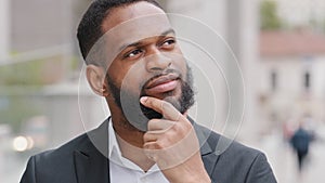 Attractive young African American student ponders his profession, career prospects. Mixed race entrepreneur boss