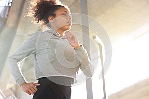 Attractive young african american woman running outdoors