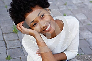 Attractive young african american woman sitting outdoors