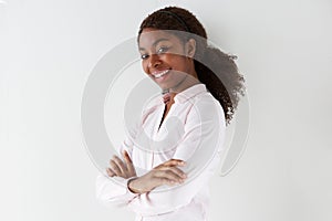 Attractive young african american woman smiling with arms crossed on white background