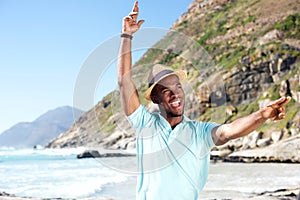 Attractive young african man having fun at the beach