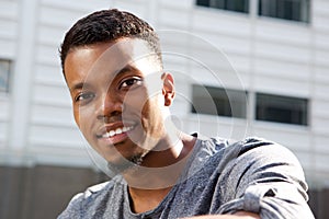 Attractive young african man smiling outside