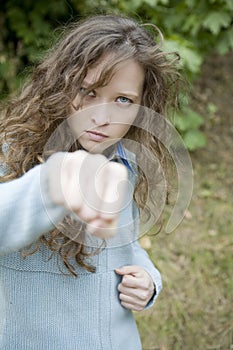 Attractive young aggressive female punching