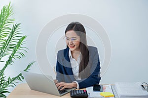 Attractive and young Asian business woman work using computer