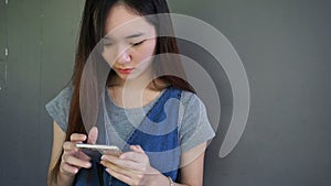 Attractive young asian chinese woman enjoy using smart phone