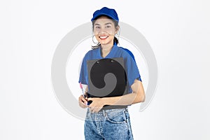 Attractive young Asian delivery woman in blue uniform with clipboard over white isolated background. Logistics and shipping