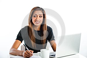 Attractive young asian indian teenage woman, studying with laptop