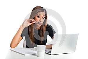 Attractive young asian indian teenage woman studying with laptop