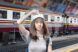 Attractive young Asian lady tourist with model airplane at train station. Travel lifestyle concept