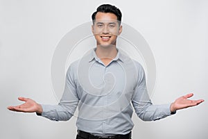 Attractive young Asian man smiling and welcoming heartily with arms open