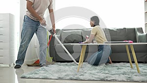 Attractive young Asian man and woman cleaning the house together happy family, beautiful