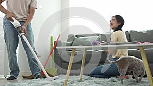 Attractive young Asian man and woman cleaning the house together happy family, beautiful