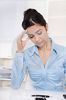 Attractive young asian secretary has migraine or headache.