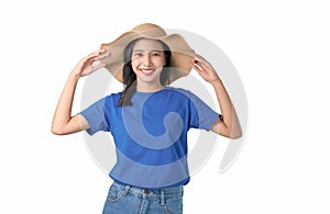 Attractive young Asian woman standing touching hat on head, feeling happy on white background.