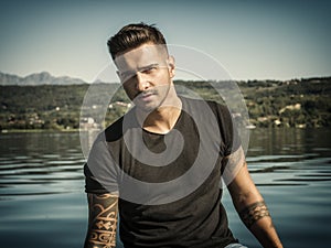 Young man standing in water in sea or lake